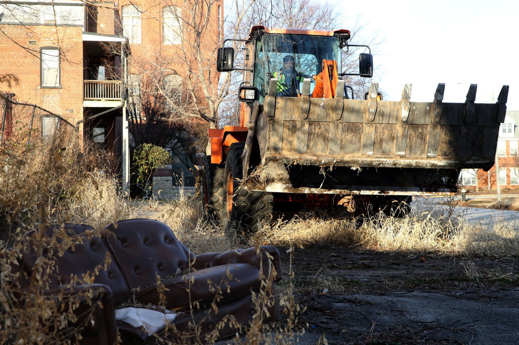 Broderick Young removes a couch in response to a CSB complaint